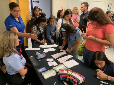 A group of girls participate in crafting at the Puerto Rico Inter american university girls in aviation day event